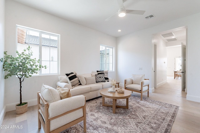 living room with ceiling fan and light hardwood / wood-style flooring