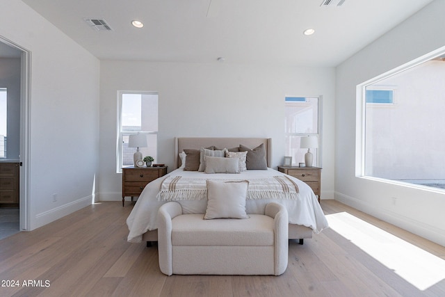 bedroom featuring light hardwood / wood-style floors and multiple windows