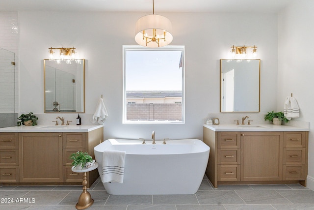 bathroom with large vanity, tile flooring, double sink, and a tub