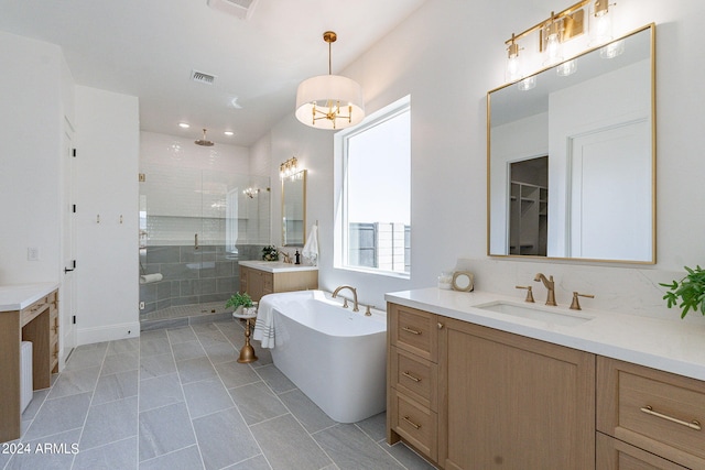 bathroom with tile flooring, plus walk in shower, and double vanity