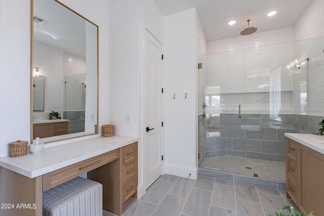 bathroom with walk in shower, vanity, and tile floors