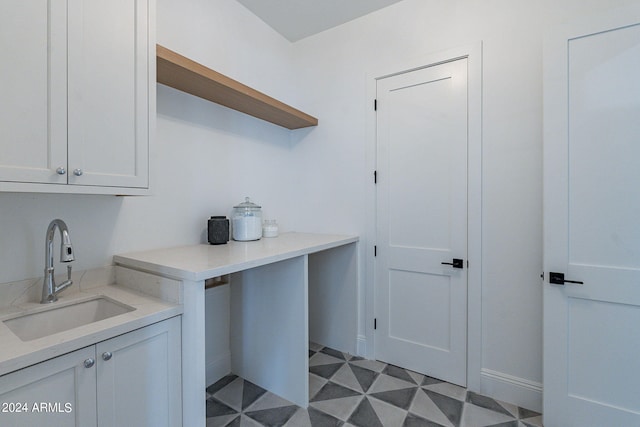 laundry area with sink and light tile floors