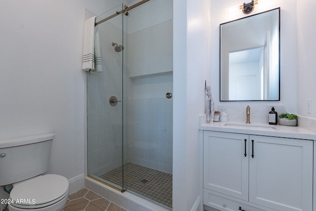 bathroom with walk in shower, vanity, toilet, and tile floors