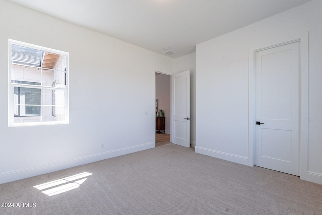 unfurnished bedroom with carpet and multiple windows