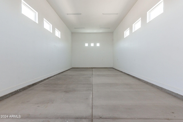 empty room featuring a wealth of natural light and concrete floors