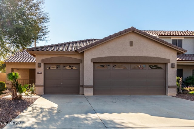 mediterranean / spanish home featuring a garage