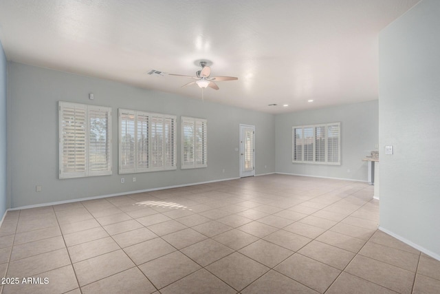 empty room with light tile patterned flooring and ceiling fan