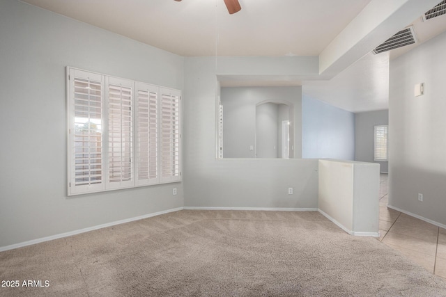 unfurnished room with ceiling fan and light colored carpet