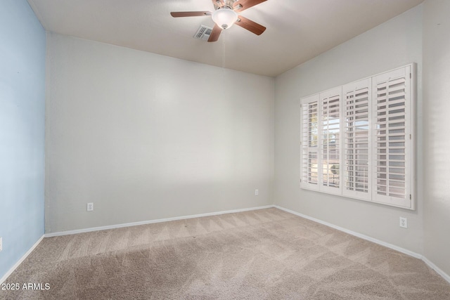 empty room with ceiling fan and carpet floors