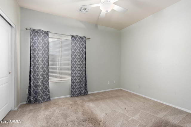 carpeted spare room with a healthy amount of sunlight and ceiling fan