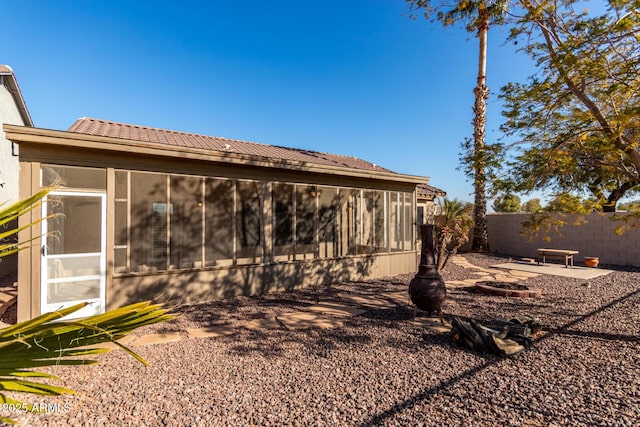 back of house with a patio area and a sunroom