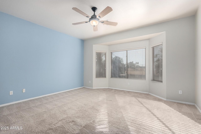 unfurnished room with ceiling fan and light colored carpet