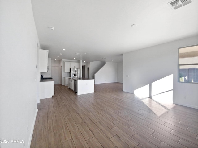 unfurnished living room featuring light hardwood / wood-style flooring