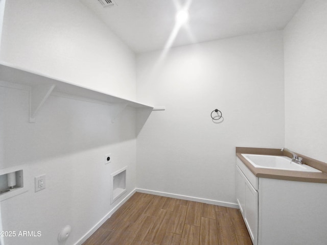 laundry room featuring hardwood / wood-style floors, cabinets, electric dryer hookup, washer hookup, and sink