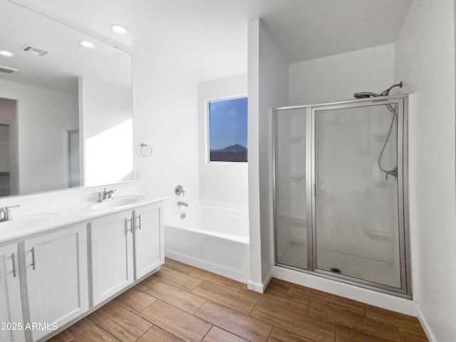 bathroom with shower with separate bathtub and vanity