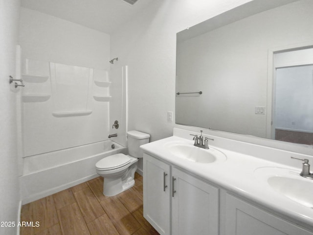 full bathroom featuring shower / tub combination, toilet, hardwood / wood-style floors, and vanity