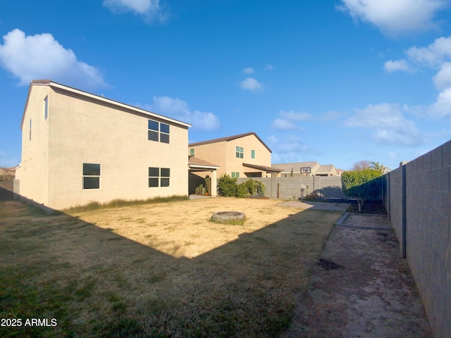 rear view of house with a yard