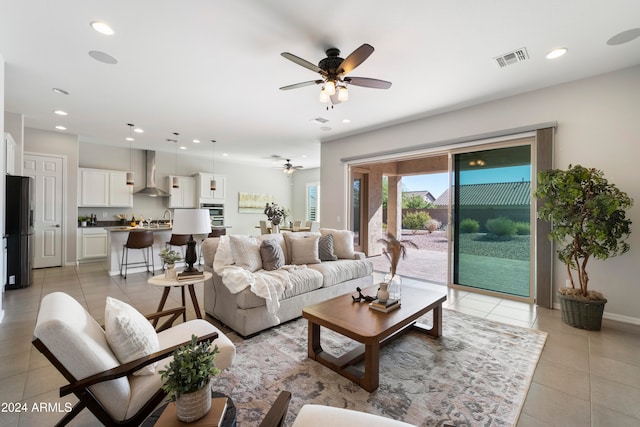 tiled living room with ceiling fan