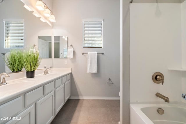 bathroom featuring vanity, tub / shower combination, and tile patterned floors