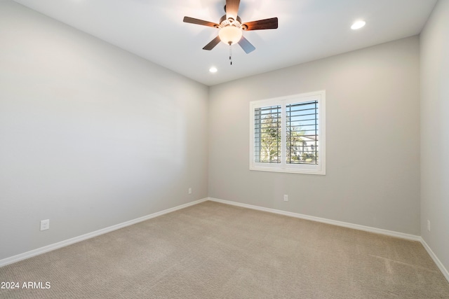 empty room featuring light carpet and ceiling fan