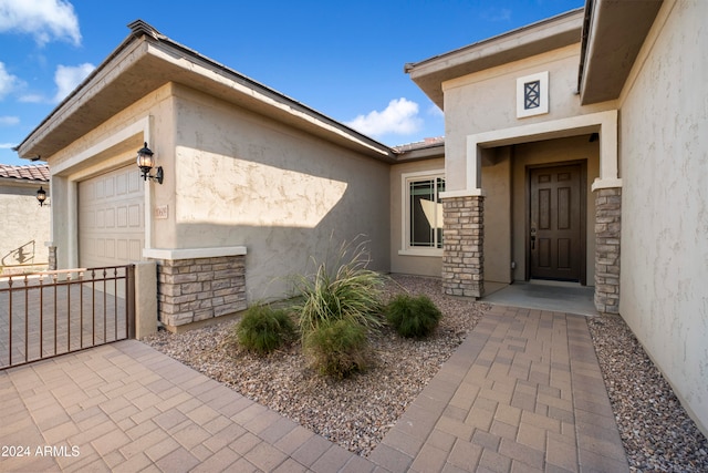 view of exterior entry with a garage