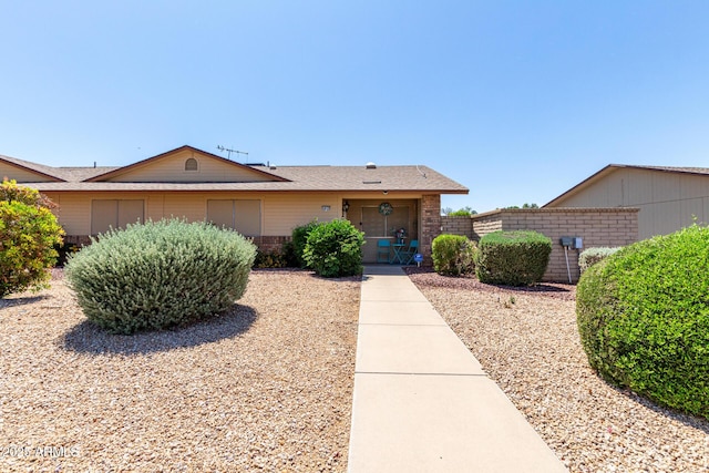 single story home featuring brick siding and fence