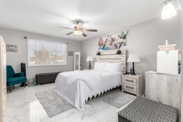 bedroom with a ceiling fan and marble finish floor