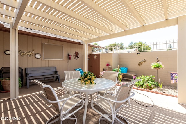 view of patio / terrace with fence, outdoor dining space, and a pergola