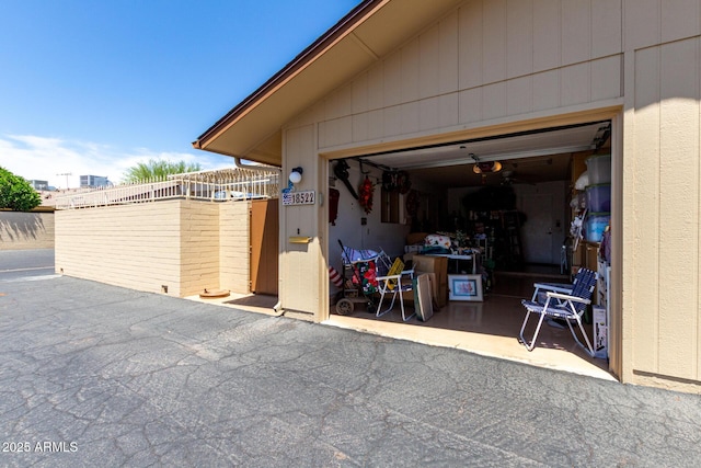 garage featuring fence and a garage door opener
