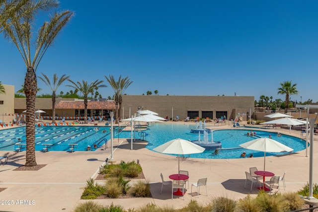 pool with fence and a patio