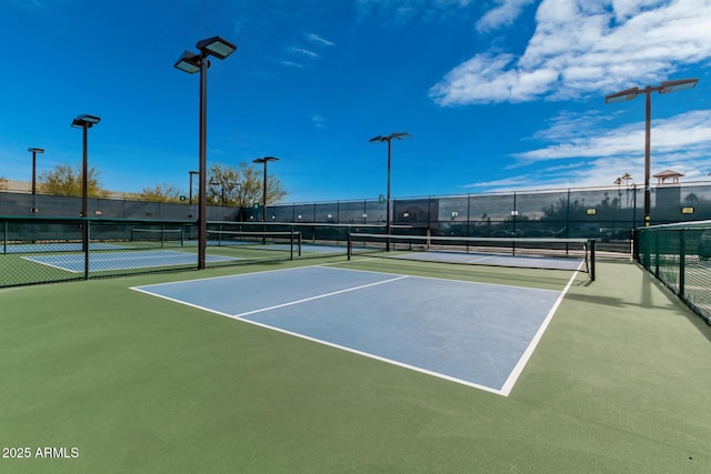 view of tennis court with fence