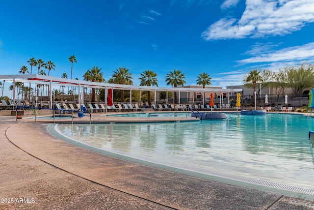 pool with fence and a patio area