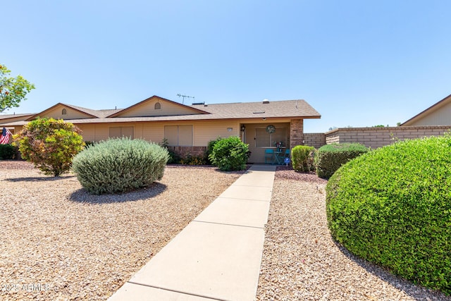 ranch-style house with brick siding and fence