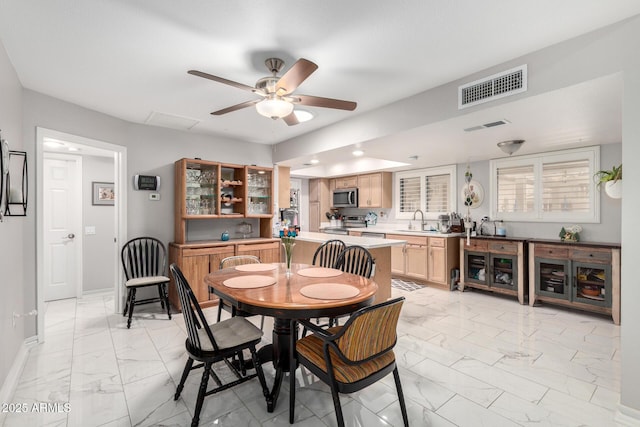dining space with baseboards, visible vents, a ceiling fan, and marble finish floor
