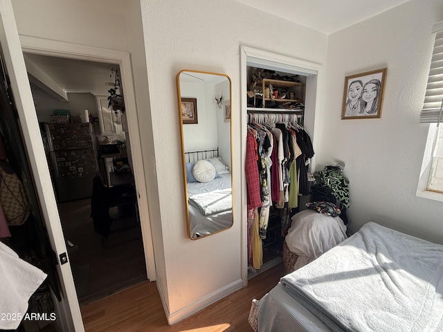 bedroom featuring wood-type flooring and a closet