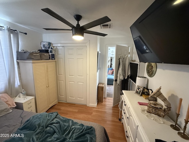 bedroom with a closet, ceiling fan, and light wood-type flooring