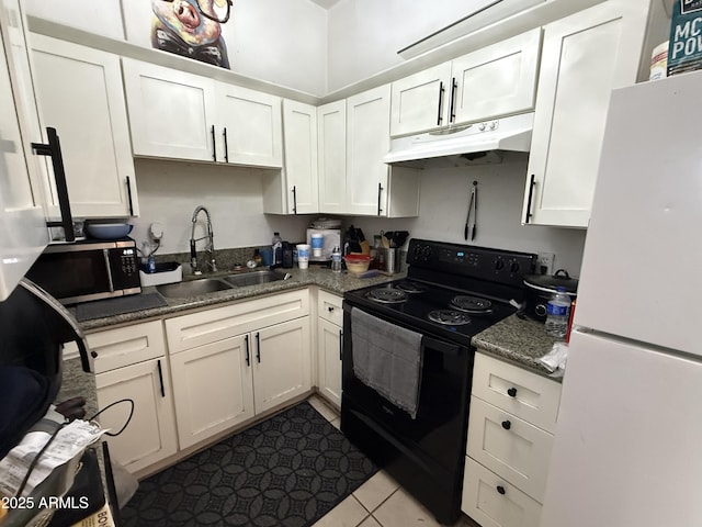 kitchen featuring black electric range oven, sink, white refrigerator, white cabinets, and light tile patterned flooring