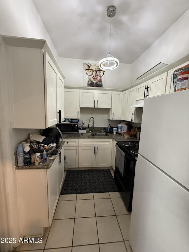 kitchen with sink, white cabinetry, light tile patterned floors, pendant lighting, and black appliances