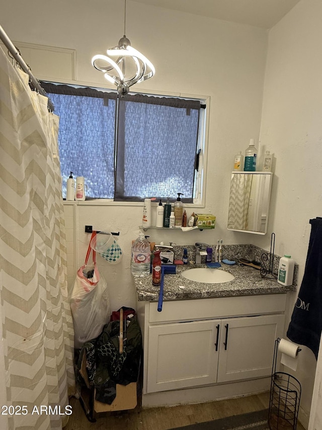 bathroom featuring vanity and a chandelier