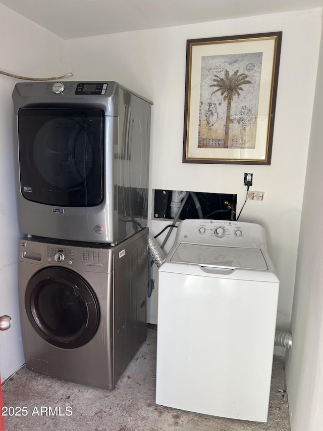 clothes washing area with stacked washer and clothes dryer