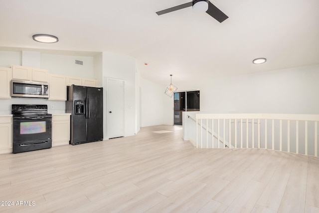 kitchen featuring light hardwood / wood-style flooring, hanging light fixtures, black appliances, vaulted ceiling, and ceiling fan