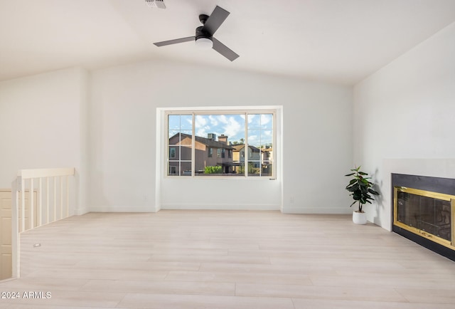 unfurnished living room featuring vaulted ceiling, light hardwood / wood-style flooring, and ceiling fan