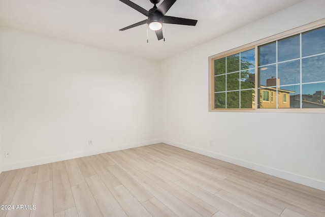 unfurnished room with light wood-type flooring and ceiling fan