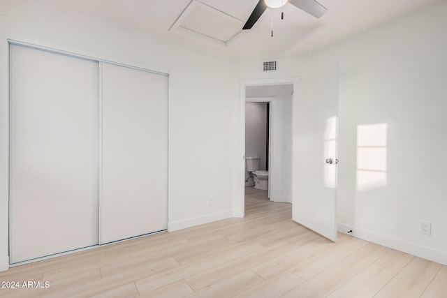 unfurnished bedroom featuring a closet, light hardwood / wood-style floors, and ceiling fan