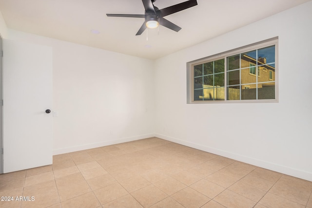 spare room with light tile patterned flooring and ceiling fan