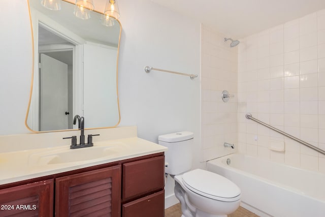 full bathroom with tiled shower / bath, vanity, and toilet