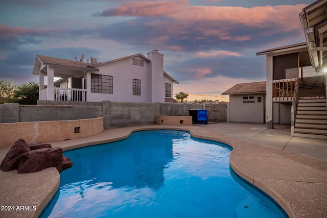 pool at dusk with a patio