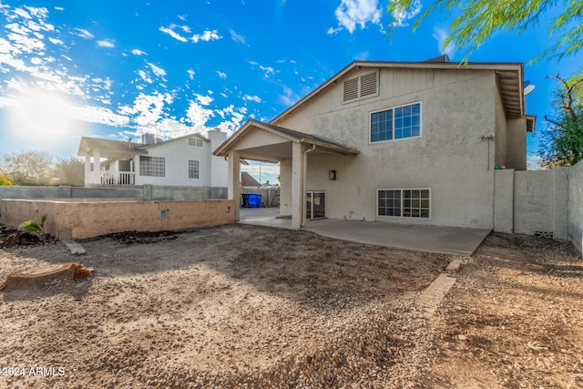 back of property with a patio