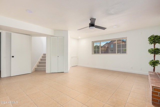 tiled empty room with ceiling fan