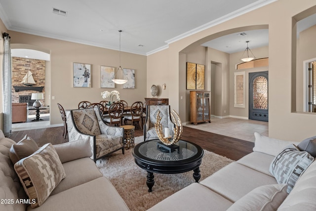 living room with wood-type flooring and crown molding